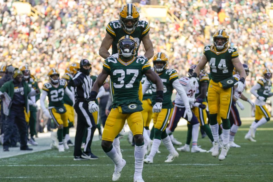 Green Bay Packers' Josh Jackson (37) and Allen Lazard (13) celebrate after the opening kickoff during the first half of an NFL football game against the Chicago Bears Sunday, Dec. 15, 2019, in Green Bay, Wis. (AP Photo/Morry Gash)