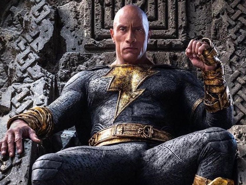 Dwayne Johnson as Black Adam sitting on the throne.