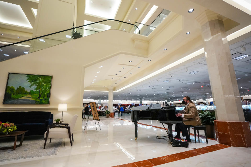 Pianist Tyler Larson plays ambiance music at the new Von Maur location in the Jordan Creek Town Center in West Des Moines.