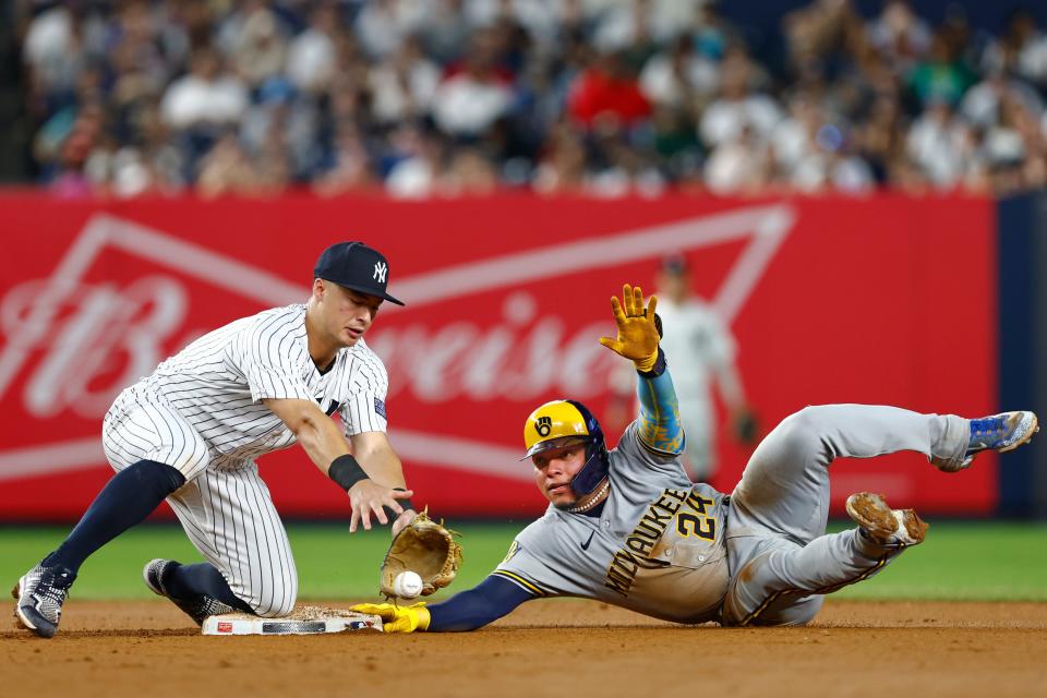 William Contreras (24) of the Milwaukee Brewers steals second base as shortstop Anthony Volpe (11) of the New York Yankees bobbles the ball during the seventh inning of a game at Yankee Stadium on September 8, 2023 in New York City.