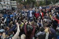 Russian opposition candidate Dmitry Gudkov, center, speaks to a crowd during a protest in Moscow, Russia, Sunday, July 14, 2019. Opposition candidates who run for seats in the city legislature in September's elections have complained that authorities try to bar them from the race by questioning the validity of signatures of city residents they must collect in order to qualify for the race. (AP Photo/Pavel Golovkin)