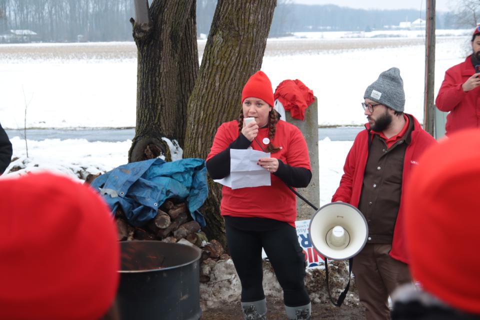 Tracy Webb, a critical care nurse at ProMedica Hickman Hospital and president of its Michigan Nurses Association local, speaks Tuesday at a "practice strike" the union staged across M-52 from the hospital.