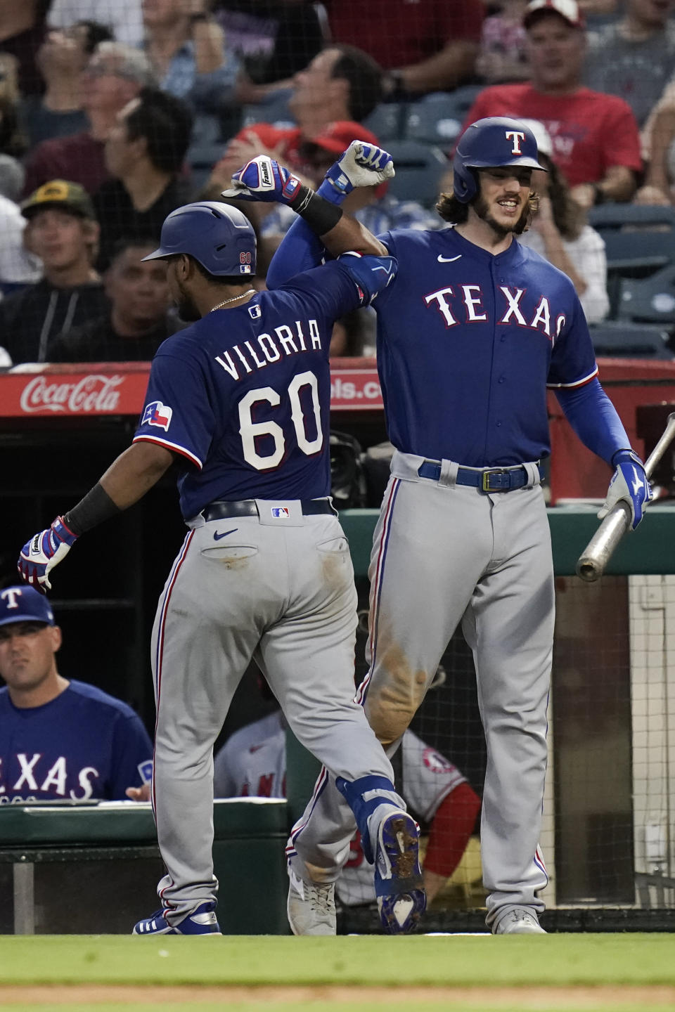 Texas Rangers' Meibrys Viloria, left, celebrates his two-run home run against the Los Angeles Angels with Jonah Heim during the sixth inning of a baseball game Saturday, July 30, 2022, in Anaheim, Calif. (AP Photo/Jae C. Hong)