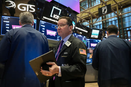 Traders work on the floor at the New York Stock Exchange (NYSE) in New York, U.S., March 22, 2019. REUTERS/Brendan McDermid