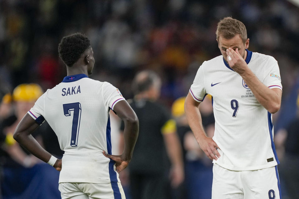 England's Harry Kane, right, and England's Bukayo Saka react at the end of the final match between Spain and England at the Euro 2024 soccer tournament in Berlin, Germany, Sunday, July 14, 2024. (AP Photo/Martin Meissner)