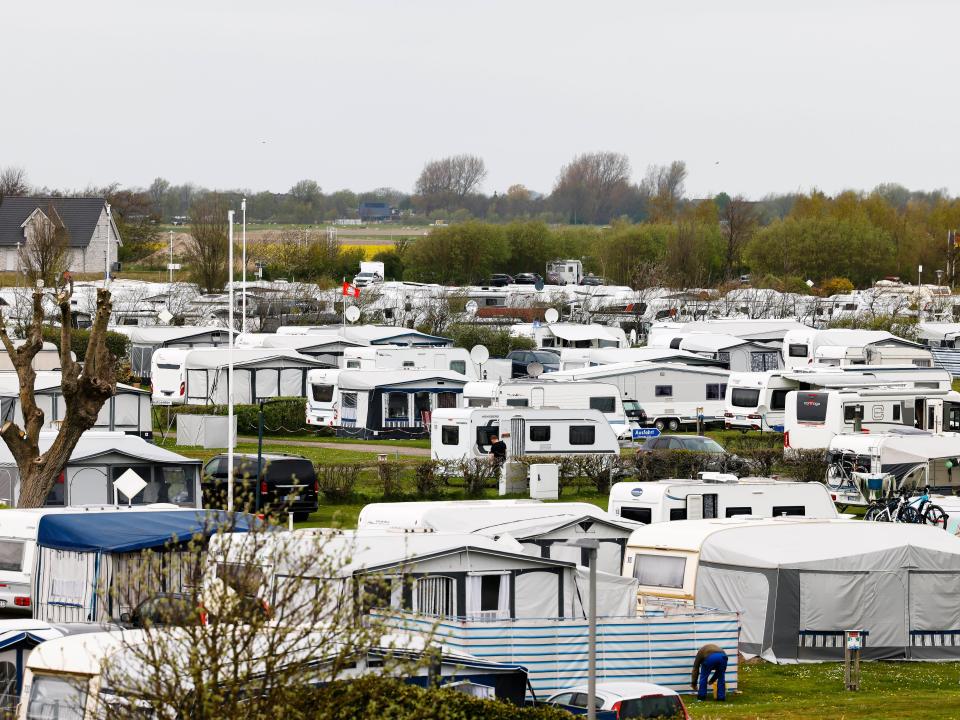 A full RV campsite with hazy grey skies.