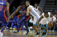 Charlotte Hornets' Devonte' Graham, far right, gathers up a loose ball as teammate Caleb Martin, middle, holds off Detroit Pistons' Langston Galloway during the first half of an NBA preseason basketball game in Charlotte, N.C., Wednesday, Oct. 16, 2019. (AP Photo/Bob Leverone)