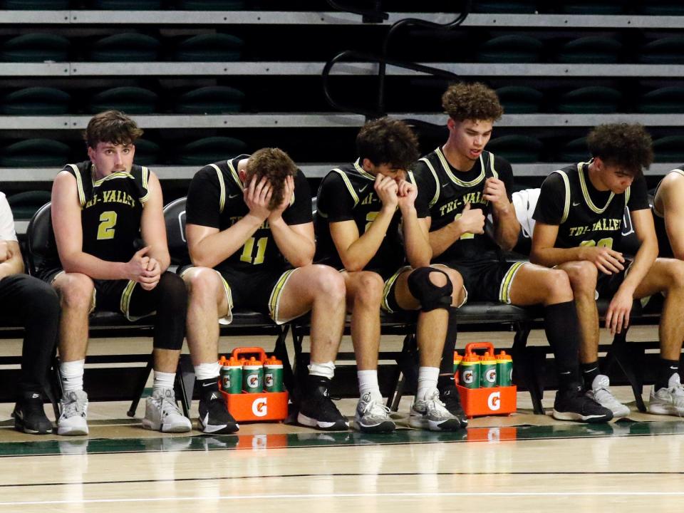Tri-Valley's Max Lyall, left, Erik Neal, Ryan Lamonica, Noah Nichols and Keaton Hahn sit on the bench in the final seconds of Tri-Valley's 65-49 loss to Vincent Warren on Thursday night during a Division II regional semifinal at the Ohio Convocation Center in Athens. The loss was Tri-Valley's second straight at the Athens regional.