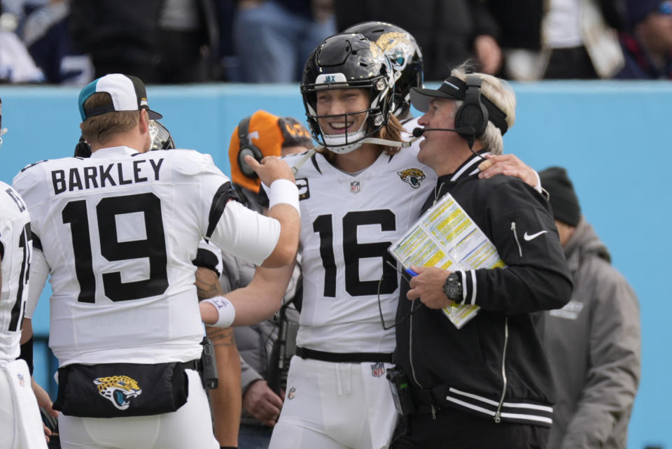 Jacksonville Jaguars quarterback Trevor Lawrence (16) celebrates his touchdown pass against the Tennessee Titans with head coach Doug Pederson, right, and Matt Barkley (19) during the first half of an NFL football game Sunday, Jan. 7, 2024, in Nashville, Tenn. (AP Photo/George Walker IV)