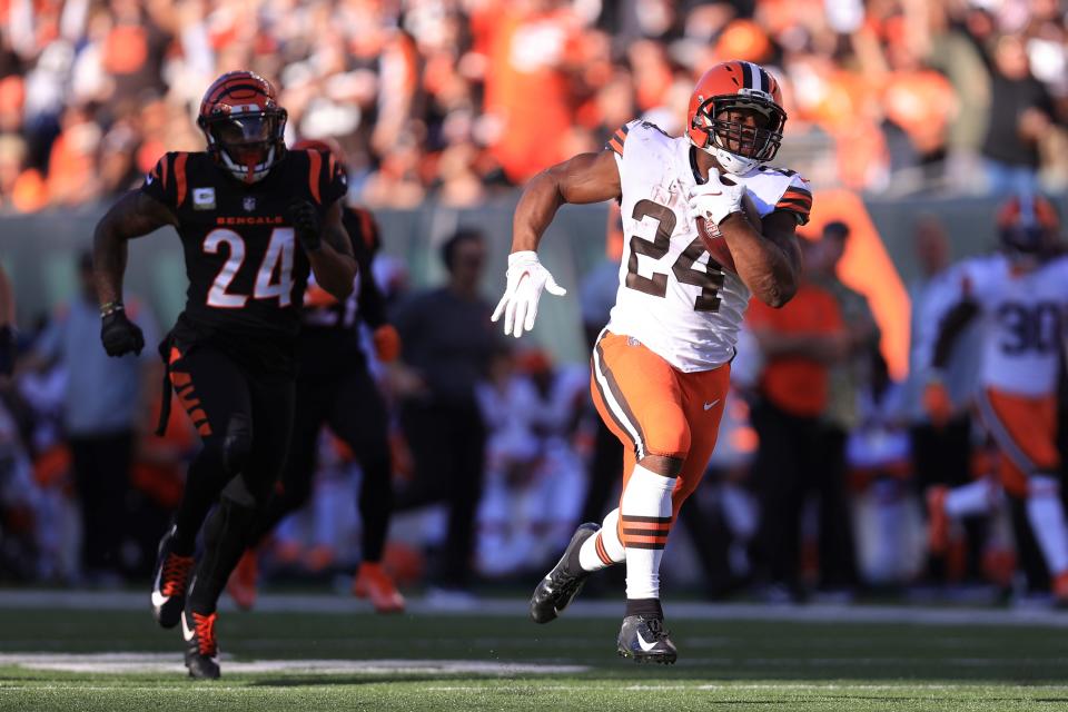 Nick Chubb runs past Bengals defensive back Vonn Bell (24) for a Browns touchdown during the second half, Sunday, Nov. 7, 2021, in Cincinnati. (AP Photo/Aaron Doster)
