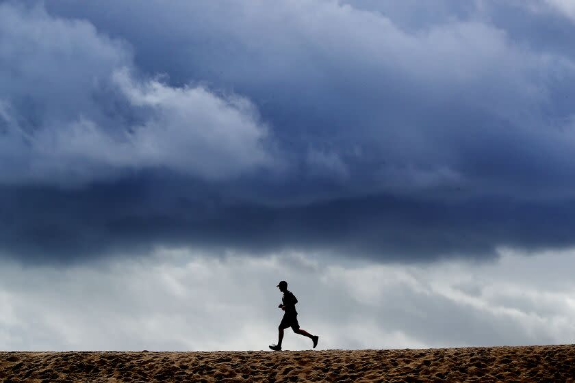 LONG BEACH, CALIF. - DEC. 12, 2022. A December storm drifts over Seal Beach, bringing inclement weather to the Southland, including rain in urban areas and snow on local mountains on Monday, Dec. 12, 2022.. (Luis Sinco / Los Angeles Times)