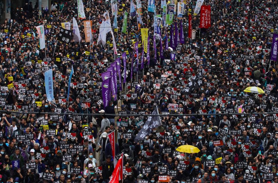 Hong Kong people participate in their annual pro-democracy march to insist their five demands be matched by the government in Hong Kong, Wednesday, Jan. 1, 2020. The five demands include democratic elections for Hong Kong's leader and legislature and a demand for a probe of police behavior during the six months of continuous protests.(AP Photo/Vincent Yu)