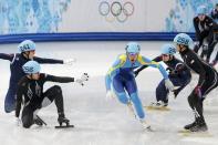 Kazakhstan's Nurbergen Zhumagaziyev (C) passes between J.R. Celski (R) and Eduardo Alvarez (front L) of the U.S. who both fell, and South Korea's Park Se-yeong and South Korea's Lee Ho-suk (back L), during the men's 5,000 metres short track speed skating relay semi-final event at the Iceberg Skating Palace during the 2014 Sochi Winter Olympics February 13, 2014. REUTERS/Lucy Nicholson (RUSSIA - Tags: SPORT SPEED SKATING OLYMPICS)