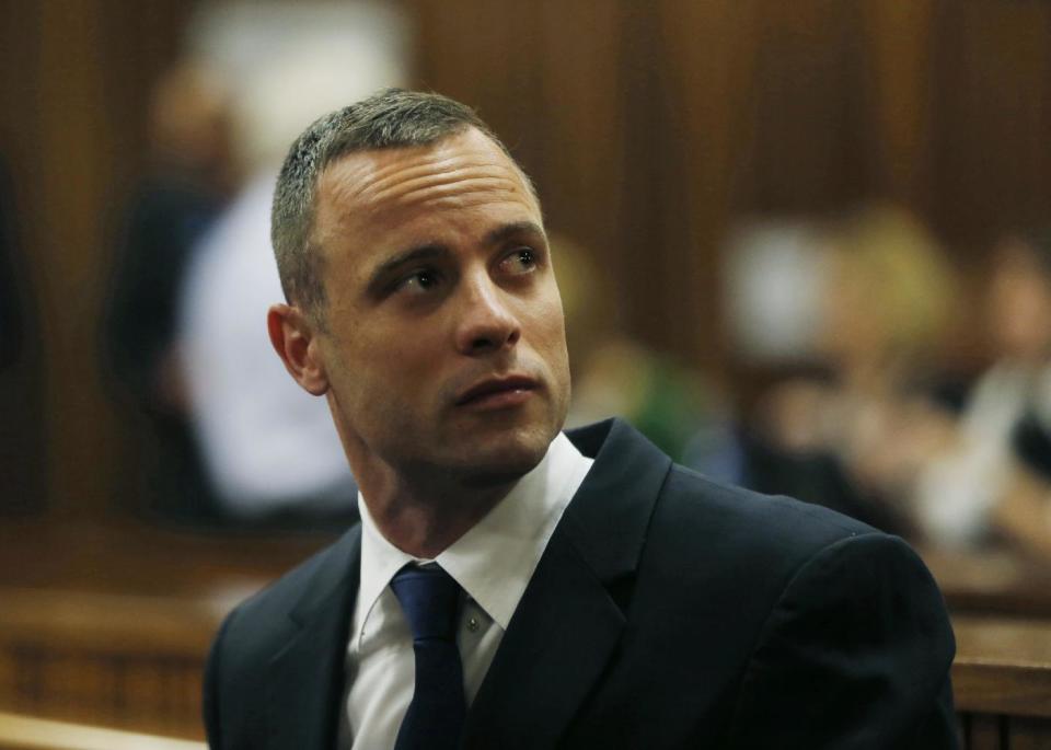 Oscar Pistorius is seated in a courtroom at the high court in Pretoria, South Africa, Tuesday, May 6, 2014. A man who lives next to the house where Pistorius fatally shot his girlfriend has testified at the athlete's murder trial about the night of the killing, saying he heard a man crying loudly and that he called the security of the housing estate for help. (AP Photo/Mike Hutchings, Pool)