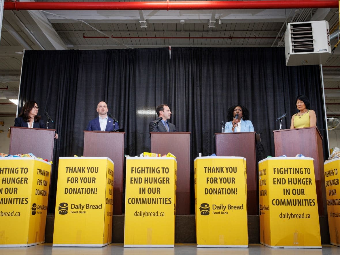 Left to right: Toronto mayoral candidates Ana Bailão, Brad Bradford, Josh Matlow, Mitzie Hunter and Olivia Chow take part in a debate, which was held at the Daily Bread Food Bank in Etobicoke on May 15, 2023. (Evan Mitsui/CBC - image credit)