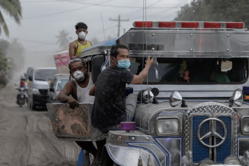 Residents affected by the erupting Taal Volcano leave their town after authorities allowed them to collect belongings and abandoned animals in Agoncillo