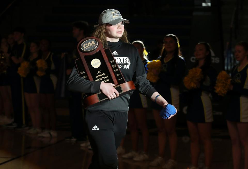 Delaware's Lizzie Oleary carries the newly-won CAA championship trophy as she is introduced as the Hens learn their destination and opening round opponent in the NCAA tournament Sunday, March 13, 2022 in a Selection Sunday event at the Bob Carpenter Center.