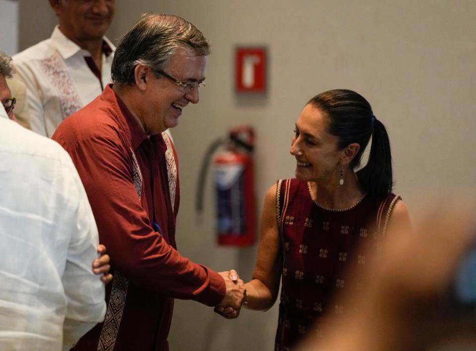 Mexico's Foreign Minister Marcelo Ebrard, left, and Mexico City's Mayor Claudia Sheinbaum shake hands during a news conference at a hotel in Mexico City, Sunday, June 11, 2023. Sheinbaum is now the ruling party´s official candidate for the next presidential elections.