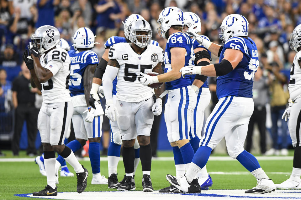 Oakland Raiders outside linebacker Vontaze Burfict (55) speaks with Indianapolis Colts tight end Jack Doyle (84) after his helmet-to-helmet hit on Doyle during the first half of an NFL football game in Indianapolis, Sunday, Sept. 29, 2019. Burfict has been suspended for the rest of the season for the hit. (AP Photo/Doug McSchooler)