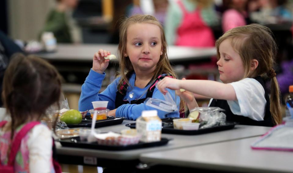 Kindergarten students at Suamico Elementary School enjoy their hot lunch on March 8, 2023, in Suamico, Wis.