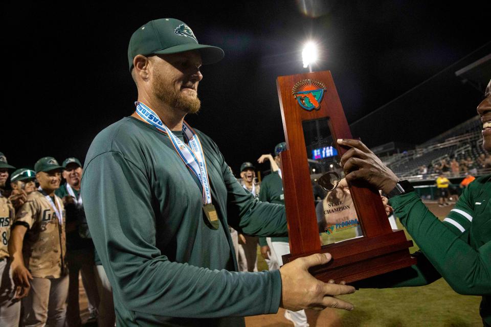 Island Coast's head coach Clint Montgomery celebrates after Island Coast defeated Jensen Beach 8-7 in eight innings to win the FHSAA baseball Class 4A state championship, Wednesday, May 25, 2022, at Hammond Stadium in Fort Myers, Fla.