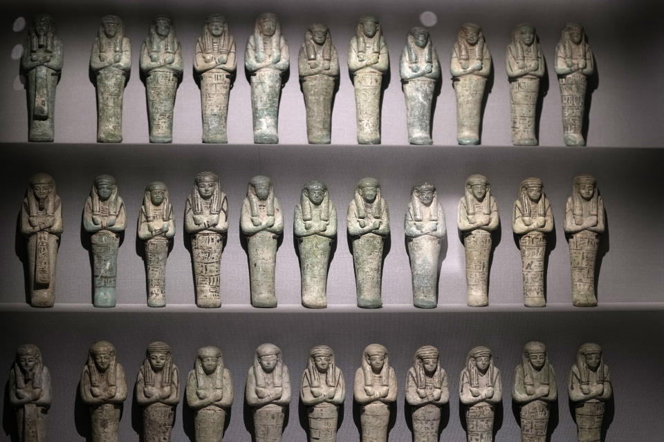 Series of bronze funerary statues of king Psusennes I, are displayed at the Egyptian museum in Cairo, Egypt, Monday, Feb. 20, 2023. Egypt's ministry of tourism and antiquities unveiled a renovated wing within its 120-year-old museum, the first stage of a broader replenishment program for the palatial building. (AP Photo/Amr Nabil)