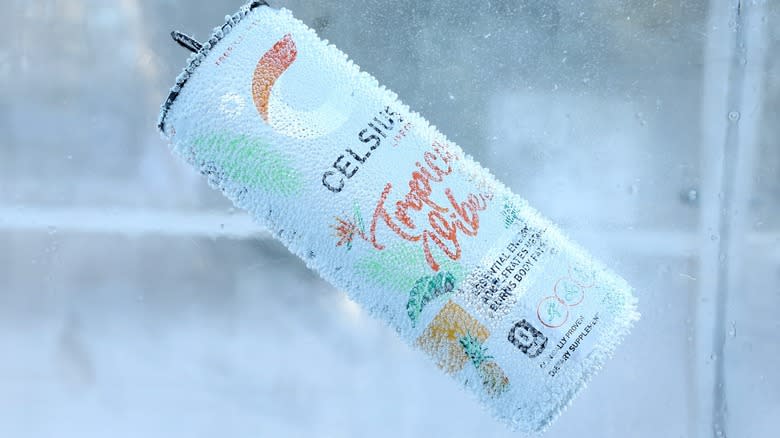 A can of Celsius energy drink chilled in ice