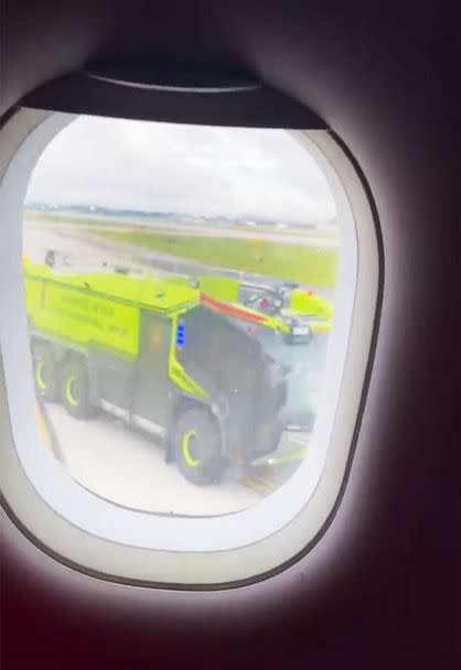 PHOTO: Emergency vehicles respond to a plane that caught fire on the tarmac of the airport in Atlanta, Juky 10, 2022. (@imgoinscottie/Twitter)