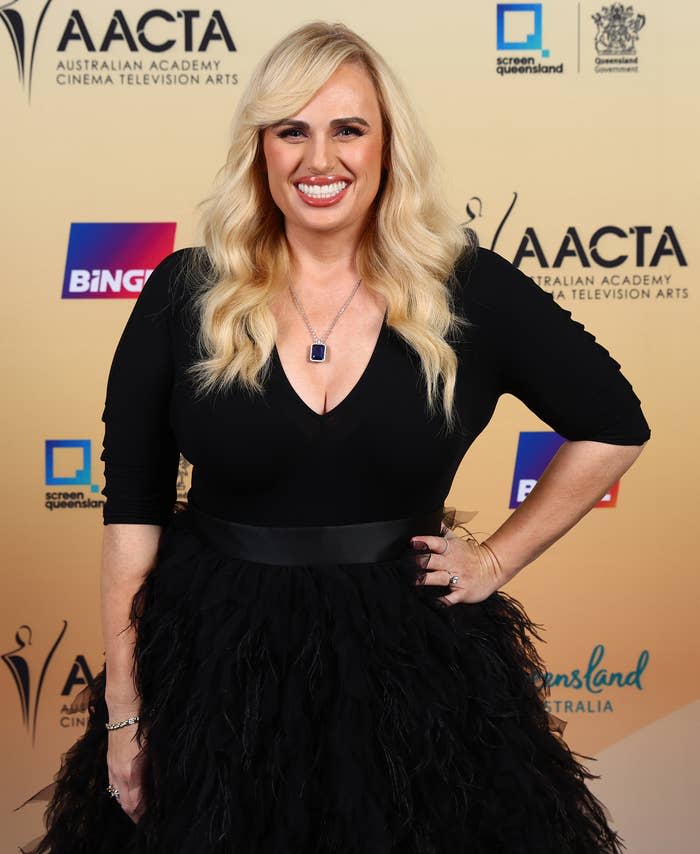 Rebel wearing a V-neck top and tulle skirt posing at an AACTA event
