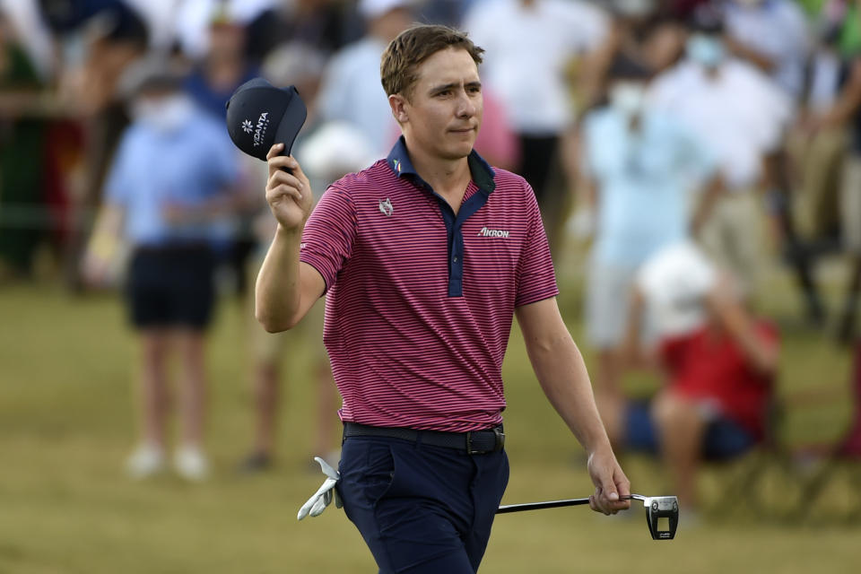 Carlos Ortiz acknowledges the gallery as he walks up the 18th green during the final round of the Houston Open golf tournament, Sunday, Nov. 8, 2020, in Houston. (AP Photo/Eric Christian Smith)