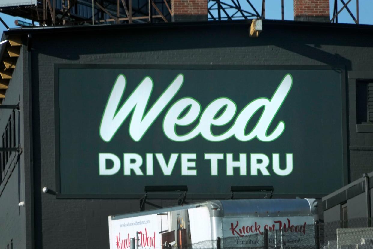 The Mother Earth Wellness sign along Interstate 95 in Pawtucket announces the dispensary's drive-thru window last week.