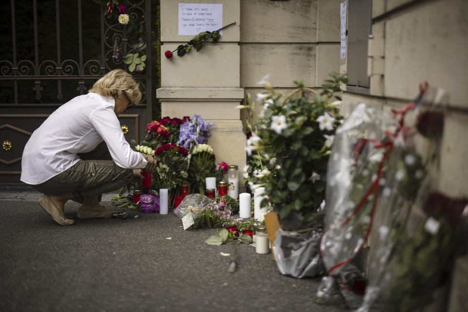 Helene lights a candle at the gate of the villa of singer and stage performer Tina Turner in Kuesnacht, Switzerland, Thursday May 25, 2023. Turner, the unstoppable singer and stage performer died Wednesday May 24, 2023, after a long illness at her home in Kuesnacht near Zurich, Switzerland, according to her manager. She was 83. (Michael Buholzer/Keystone via AP)