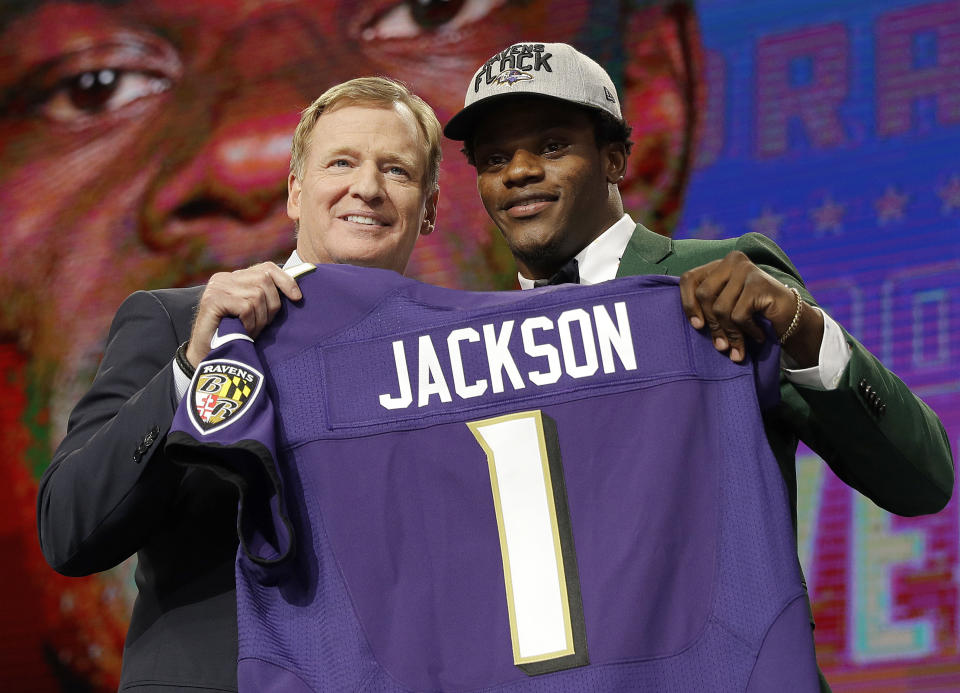 FILE - Commissioner Roger Goodell, left, presents Louisville's Lamar Jackson with his Baltimore Ravens jersey during the first round of the NFL football draft, Thursday, April 26, 2018, in Arlington, Texas. The success stories are the reason why teams keep coming back hoping to get their franchise-lifting quarterback success story like Patrick Mahomes, Josh Allen, Lamar Jackson or Joe Burrow. (AP Photo/David J. Phillip, File)