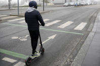 A man rides his electric scooter on a bridge of Lille, northern France, Thursday, Dec. 5, 2019. The Eiffel Tower shut down Thursday, France's vaunted high-speed trains stood still and teachers walked off the job as unions launched nationwide strikes and protests over the government's plan to overhaul the retirement system. (AP Photo/Michel Spingler)