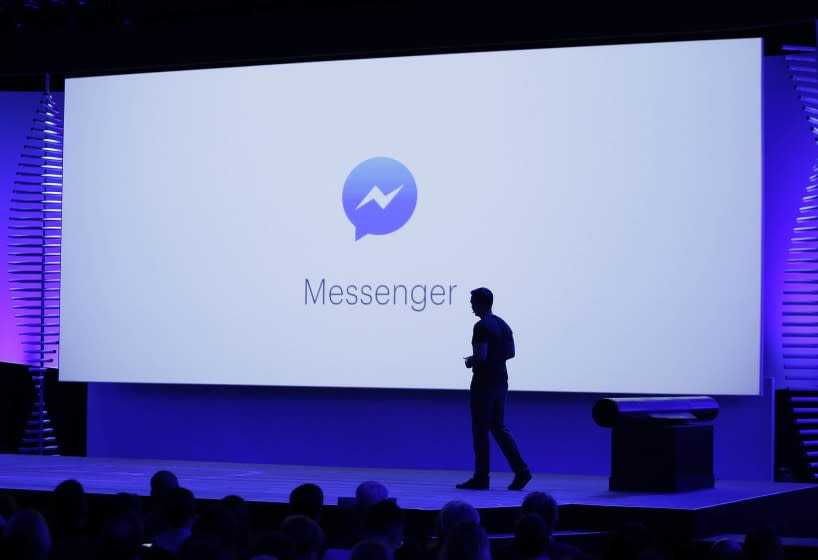 FILE - In this Tuesday, April 12, 2016, file photo, new features of Messenger are displayed during the keynote address at the F8 Facebook Developer Conference in San Francisco. Facebook has squeezed just about as many ads into its main platform as it can. Any more and users might start to complain. Now, ads are moving on to Messenger, and WhatsApp may not be too far behind. (AP Photo/Eric Risberg, File)