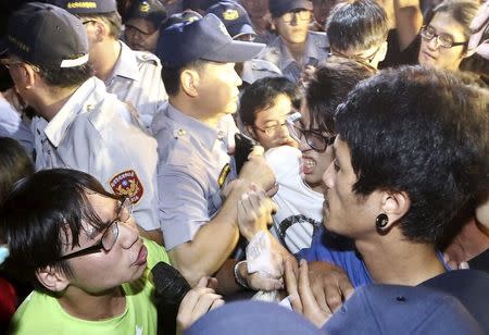 Activists scuffles with police officers during a protest in front of Ministry of Education in Taipei, Taiwan, July 24, 2015. REUTERS/Stringer/Files