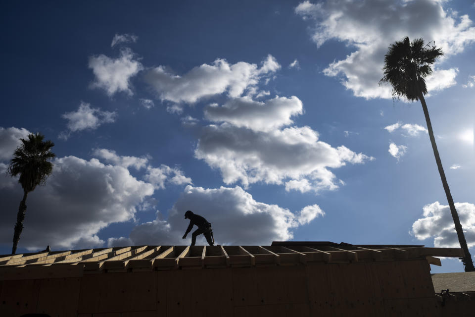 A construction worker is silhouetted agains the sky in Fontana, Calif., Wednesday, Dec. 7, 2022. Voters in one of Southern California's largest counties have delivered a pointed if largely symbolic message about frustration in the nation's most populous state: Officials will soon begin studying whether to break free from California and form a new state. (AP Photo/Jae C. Hong)