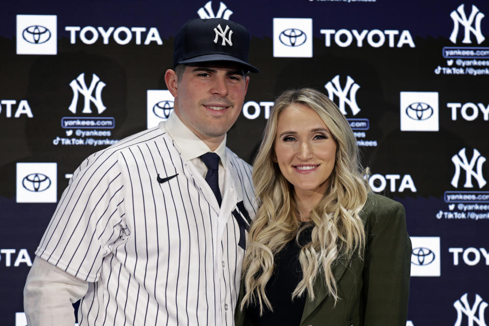 New York Yankees' Carlos Rodon poases for a photo with his wife Ashley during his introductory baseball news conference at Yankee Stadium, Thursday, Dec. 22, 2022, in New York. (AP Photo/Adam Hunger)