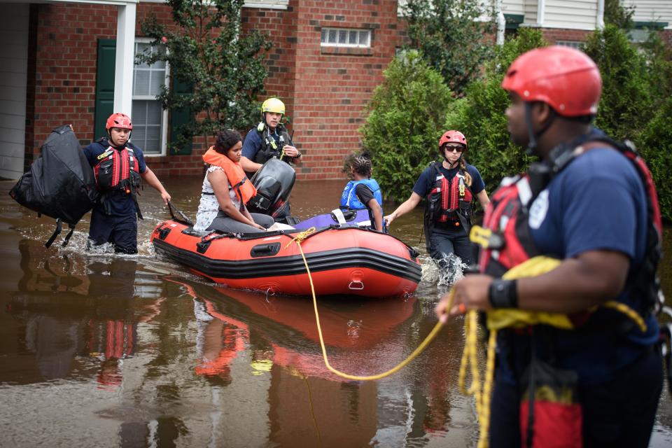 Emergency personnel in Spring Lake, N.C., take a family to safety after flooding from Hurricane Florence on Sept. 17, 2018.