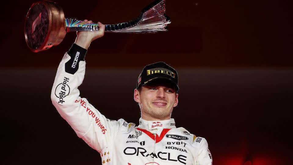 Max Verstappen celebrates with the trophy on the podium. - Mike Blake/Reuters