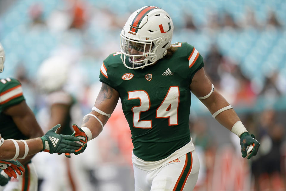 Miami running back Cody Brown (24) is congratulated after scoring s touchdown during the first half of an NCAA college football game against Central Connecticut State, Saturday, Sept. 25, 2021, in Miami Gardens, Fla. (AP Photo/Lynne Sladky)