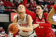 North Carolina State's Elissa Cunane (33) looks towards the basket ahead of Georgia's Jenna Staiti (14) during the second half of an NCAA college basketball game, Thursday, Dec. 16, 2021, in Raleigh, N.C. (AP Photo/Karl B. DeBlaker)