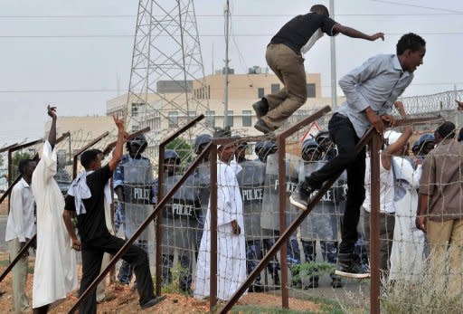 Sudanese protesters climb over a fence outside the US embassy in Khartoum on September 14 during a protest against an amateur film mocking Islam. Furious protesters targeted symbols of US influence in cities across the Muslim world on Friday, attacking embassies, schools and restaurants in retaliation for a film that mocks Islam