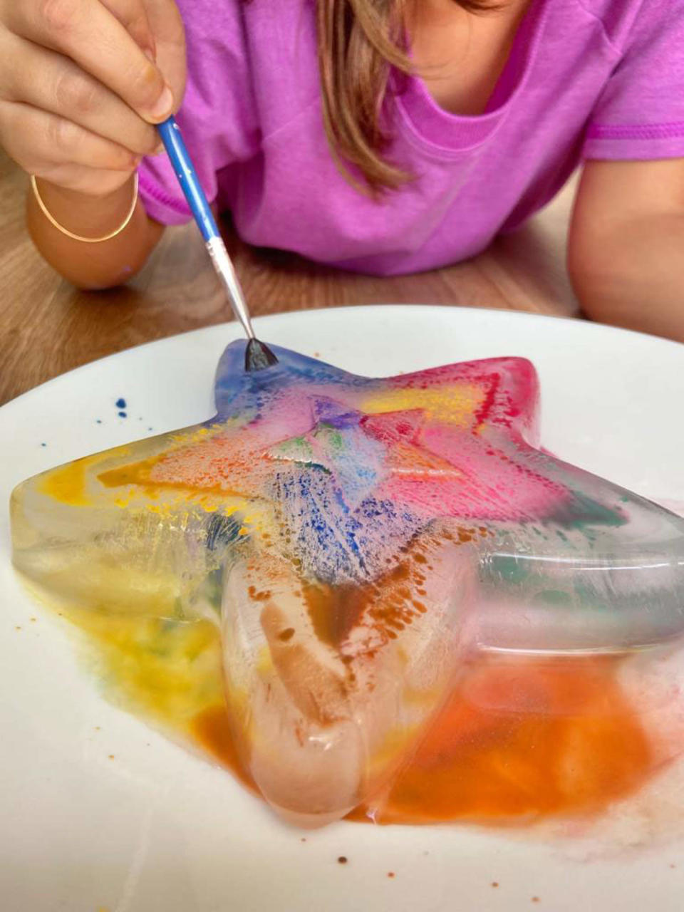 child painting on a star (Courtesy Stephanie Pflucker and Katrina Suarez)