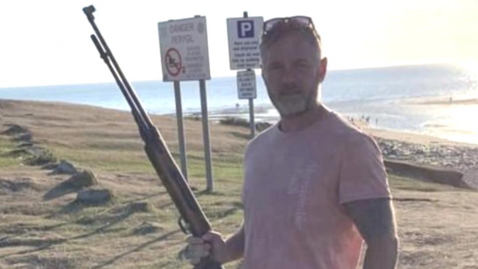 Councillor Jon Scriven's Facebook post showed him holding a gun