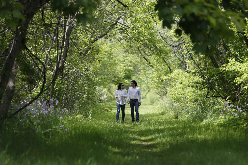 Mary Rose Maher and her fiance, William Chundrlik, walk through woods near a former Opus Bono Sacerdotii location in Dryden, Mich., on Wednesday, June 5, 2019. Opus Bono’s finances came under scrutiny after authorities were contacted by a once-loyal employee - Mary Rose, the daughter of co-founder Joe Maher - who began questioning the way money was spent. (AP Photo/Paul Sancya)