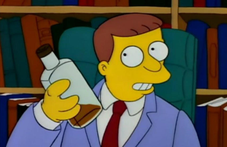 Lionel Hutz sits in a desk chair, a bookshelf behind him, and he's holding a near-empty bottle of whiskey