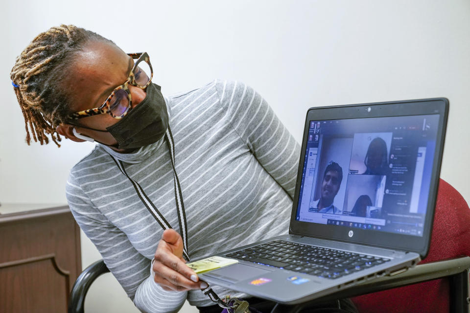 High School Councilor Nadia Pearce, right, speaks to a group of Juniors and Seniors via video conference, Thursday, Feb. 25, 2021, in Bridgeport. Conn. School counselors in many urban, high needs districts have been consumed with efforts to help students engage with their schoolwork since the pandemic hit. (AP Photo/Mary Altaffer)