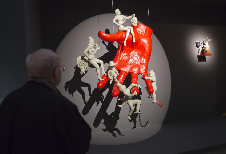 In this photo taken Tuesday, Oct. 29, 2013, a man looks at a sculpture entitled 'a la main du diable, 2013' by French artist Arnaud Labelle-Rojoux, during a press viewing for the exhibition 'Surrealism and the object', at the Pompidou Center in Paris. The exhibition at Paris' Pompidou Center tells the previously untold story of how the Surrealists managed to reconcile their fantastical dreams and Marxist politics by channeling their artistic message through everyday objects. The exhibition runs from Oct. 30, 2013 until March 3, 2014. (AP Photo/Michel Euler)