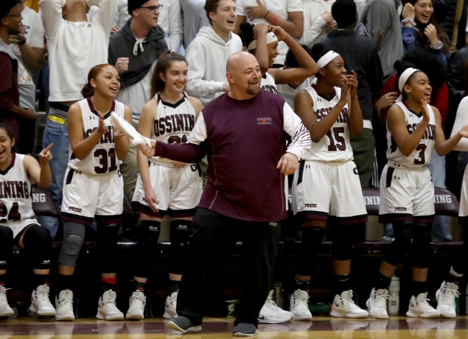 Ossining head coach Dan Ricci and his players celebrate near the end of a Class AA girls basketball regional semifinal at Ossining High School March 5, 2019. Ossining defeated Elmira 98-58.